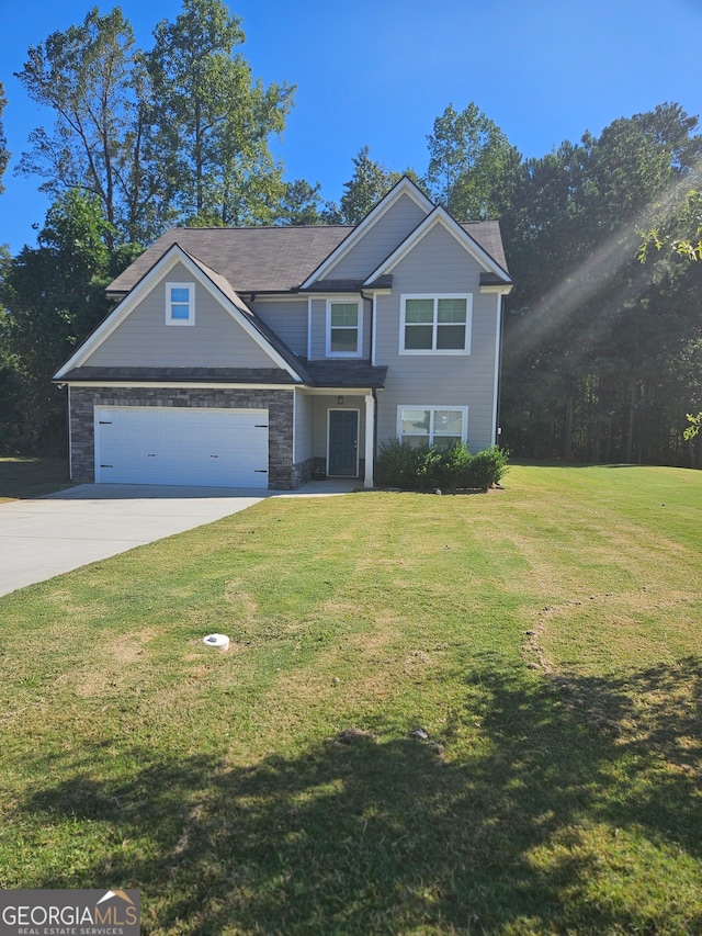 view of front of home featuring a front yard and a garage