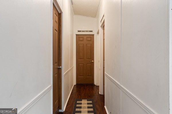 hall with dark wood-type flooring