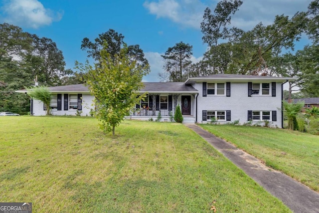 view of front of property with a porch and a front lawn