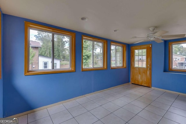 tiled empty room with ceiling fan