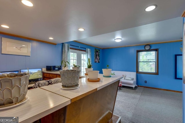 kitchen with light carpet, plenty of natural light, french doors, and crown molding