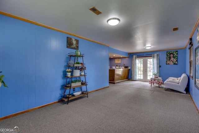 unfurnished room with french doors, light colored carpet, and ornamental molding