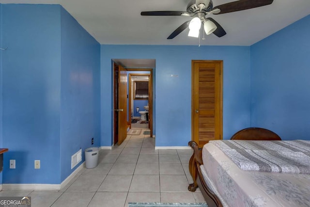 tiled bedroom featuring ceiling fan and a closet