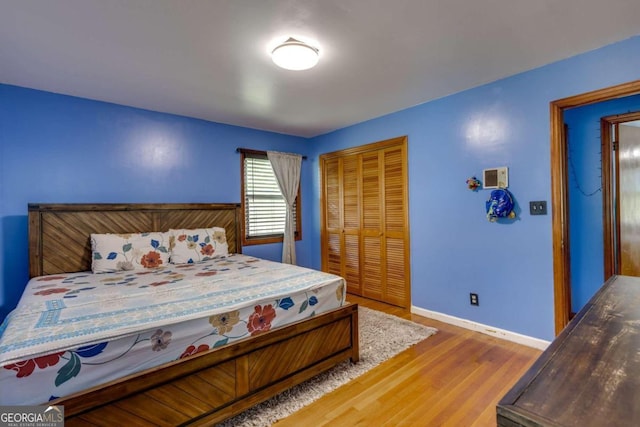 bedroom with a closet and hardwood / wood-style floors