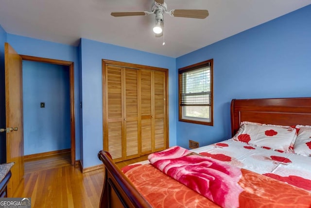 bedroom featuring ceiling fan, a closet, and light hardwood / wood-style floors