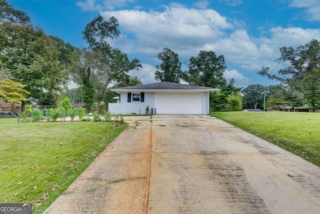 view of front of home featuring a front yard and a garage