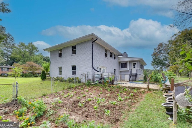 rear view of house with a lawn