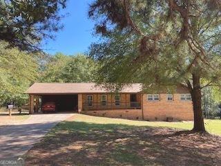 view of front of home with a carport