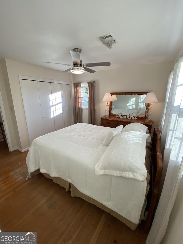 bedroom featuring ceiling fan, hardwood / wood-style floors, and a closet