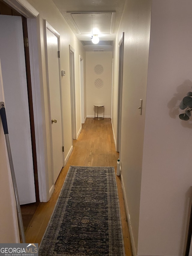 hallway with light hardwood / wood-style flooring