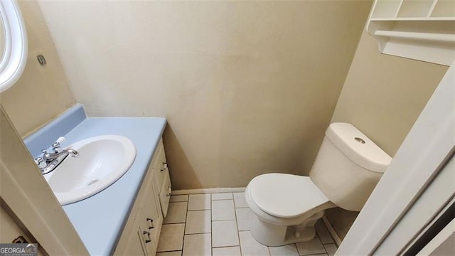 bathroom with tile patterned floors, vanity, and toilet