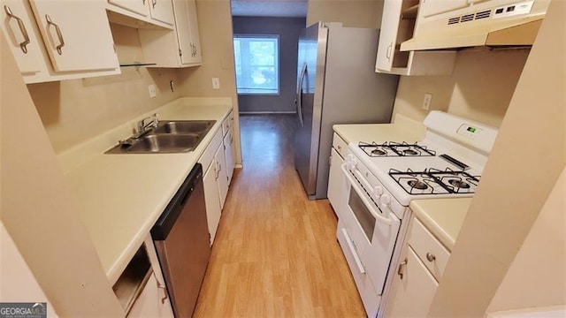 kitchen featuring light wood-type flooring, exhaust hood, white range with gas cooktop, white cabinetry, and dishwasher