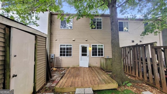 back of property with a wooden deck