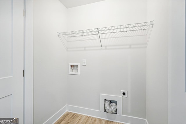 clothes washing area with hardwood / wood-style flooring, hookup for a washing machine, and hookup for an electric dryer