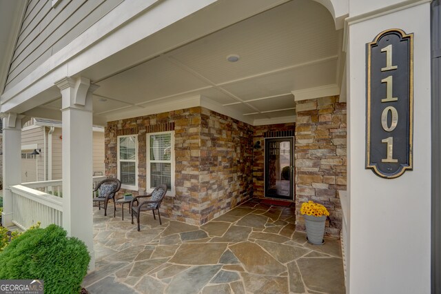 view of exterior entry featuring a porch