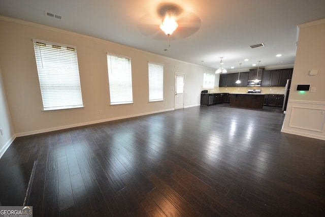 unfurnished living room featuring crown molding, ceiling fan, and dark hardwood / wood-style flooring