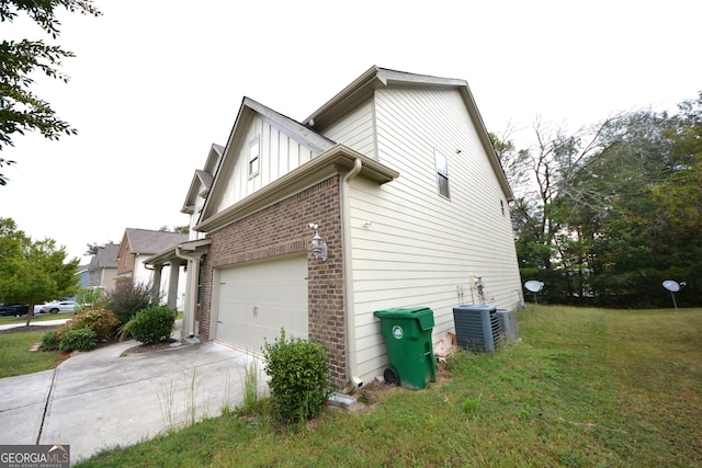 view of home's exterior with cooling unit and a yard