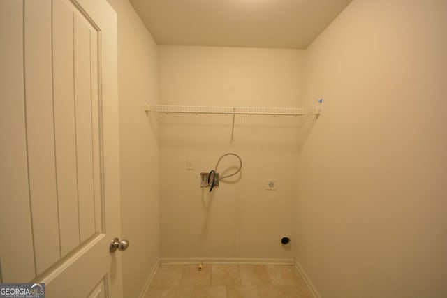 laundry area featuring light tile patterned floors and electric dryer hookup