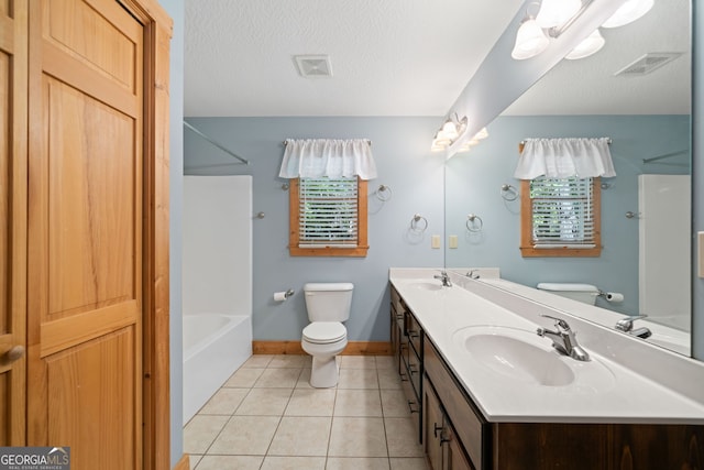 full bathroom featuring vanity, tile patterned flooring, toilet, and a textured ceiling