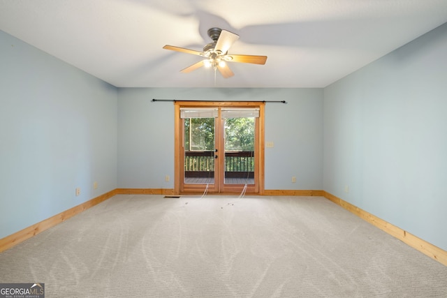 carpeted empty room featuring ceiling fan