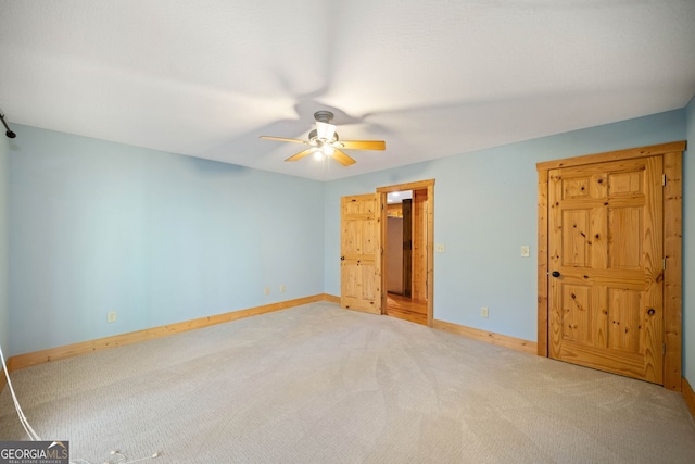 unfurnished bedroom featuring ceiling fan and carpet