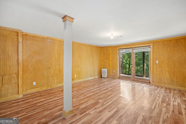 interior space with wood walls and hardwood / wood-style floors