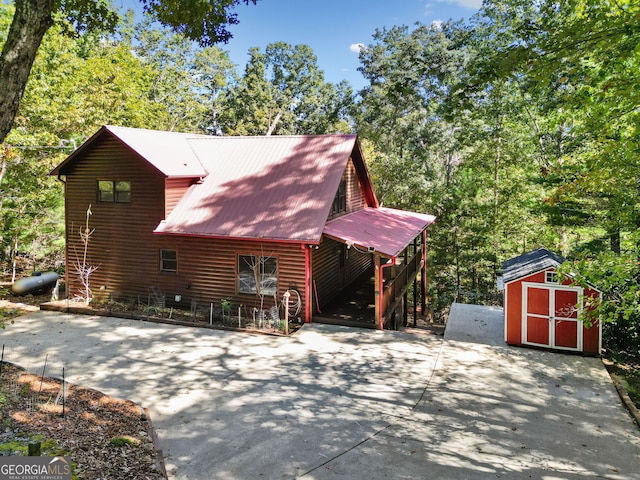 view of side of property featuring a storage unit