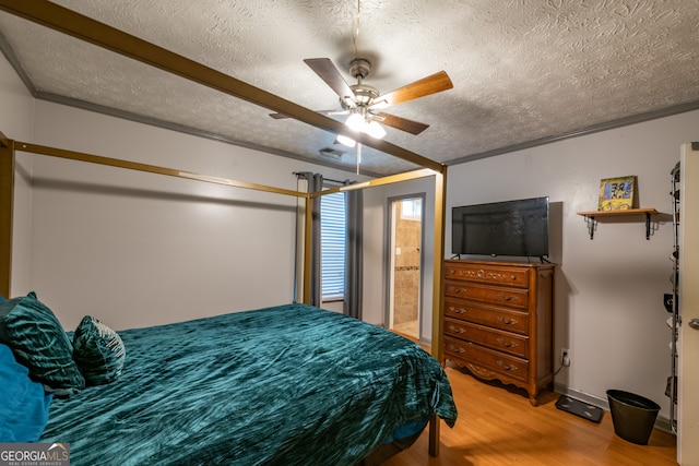 bedroom featuring ornamental molding, ceiling fan, a textured ceiling, and wood-type flooring