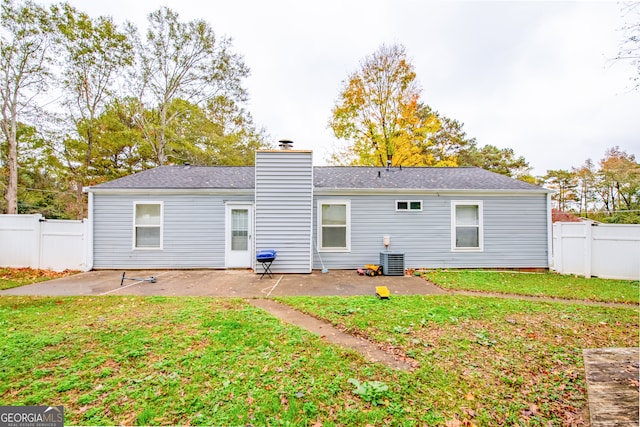 back of property featuring a lawn, central AC, and a patio area