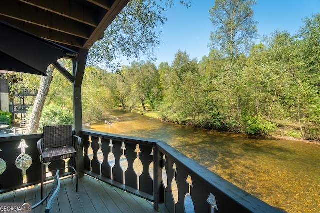 wooden deck featuring a water view