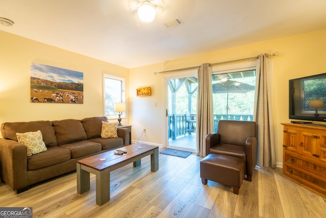 living room featuring ceiling fan and light hardwood / wood-style flooring