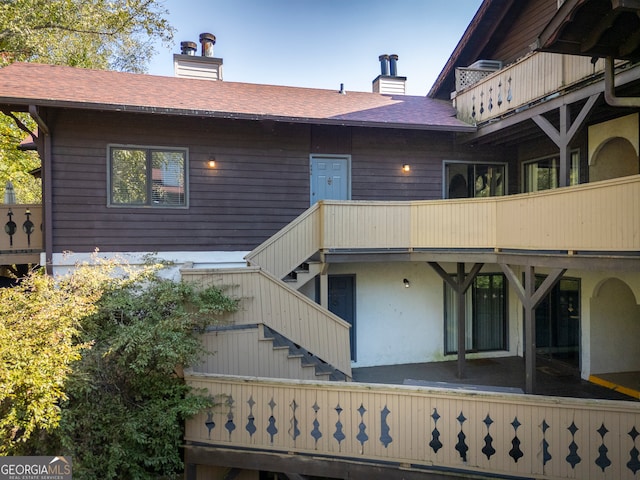 rear view of property with a balcony