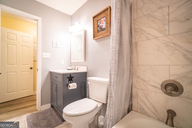 full bathroom with hardwood / wood-style floors, toilet, vanity, and shower / bathtub combination with curtain