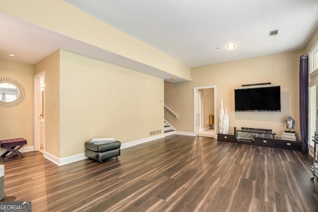 unfurnished living room featuring a healthy amount of sunlight and dark hardwood / wood-style flooring