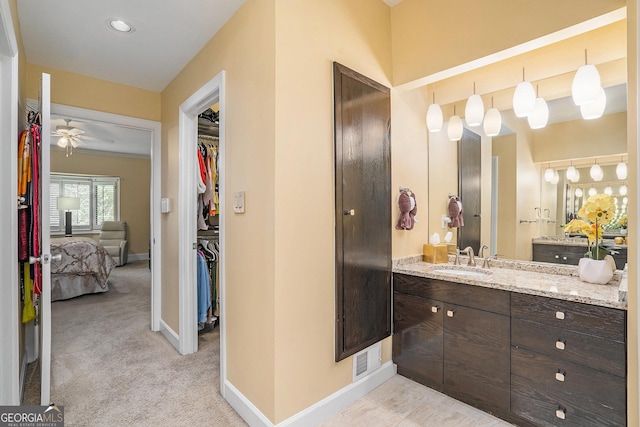 bathroom featuring ceiling fan and vanity