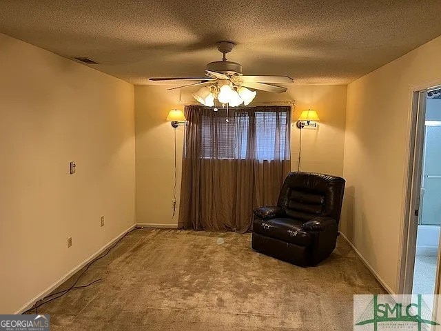 unfurnished room featuring carpet flooring, a textured ceiling, ceiling fan, and a healthy amount of sunlight