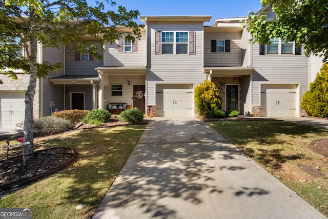 view of property with a garage and a front lawn