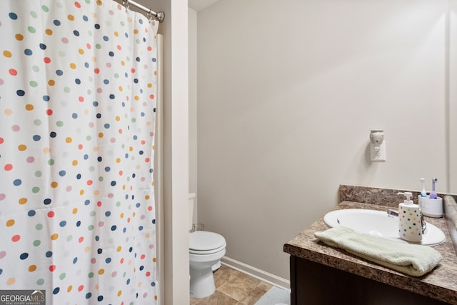 bathroom featuring vanity, toilet, and curtained shower