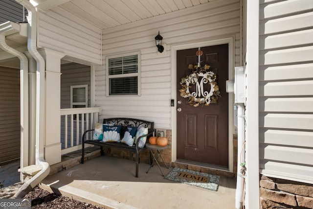 view of exterior entry with a porch