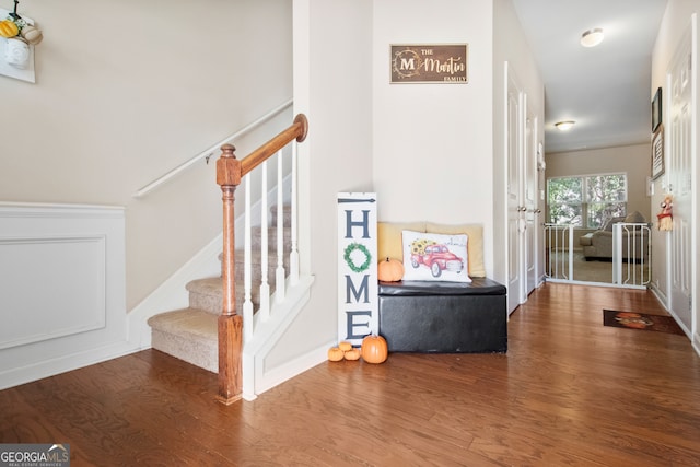 staircase with hardwood / wood-style floors