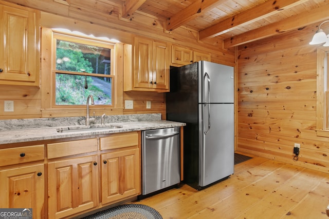 kitchen featuring beamed ceiling, sink, wooden walls, appliances with stainless steel finishes, and light hardwood / wood-style floors