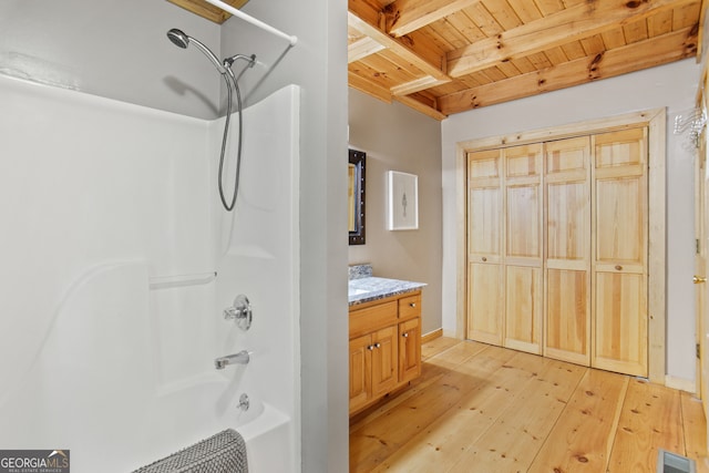 bathroom featuring beamed ceiling, washtub / shower combination, vanity, wood-type flooring, and wooden ceiling