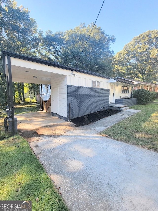 view of property exterior with a lawn and a carport