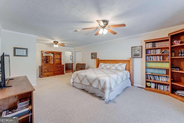 carpeted bedroom featuring ceiling fan, a textured ceiling, and ornamental molding