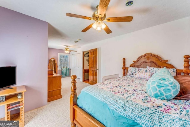 bedroom with light carpet and ceiling fan