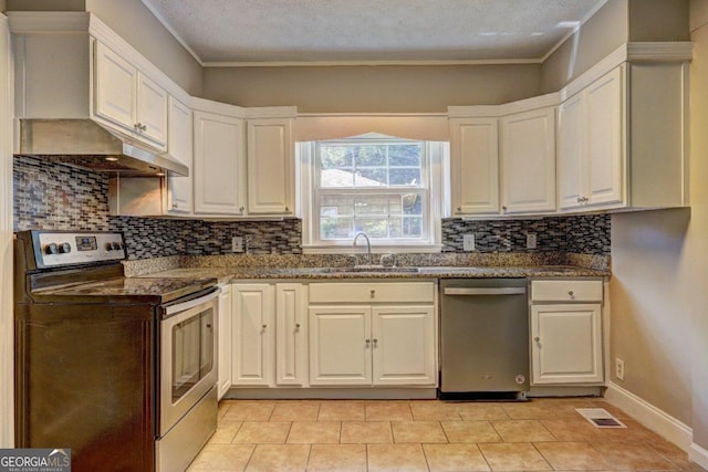 kitchen with white cabinets, appliances with stainless steel finishes, light tile patterned floors, and sink