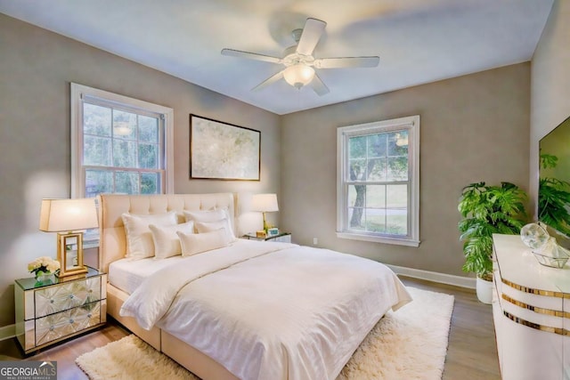 bedroom with hardwood / wood-style flooring and ceiling fan