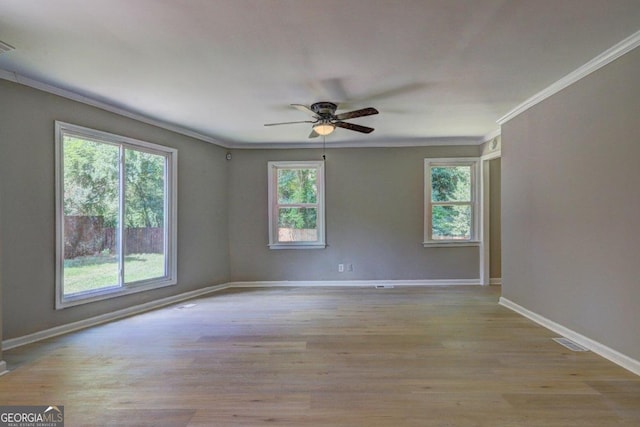 spare room with ceiling fan, light wood-type flooring, and crown molding