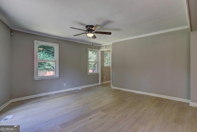 empty room with crown molding, light hardwood / wood-style flooring, and ceiling fan