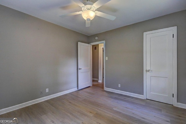 unfurnished bedroom with light hardwood / wood-style floors and ceiling fan